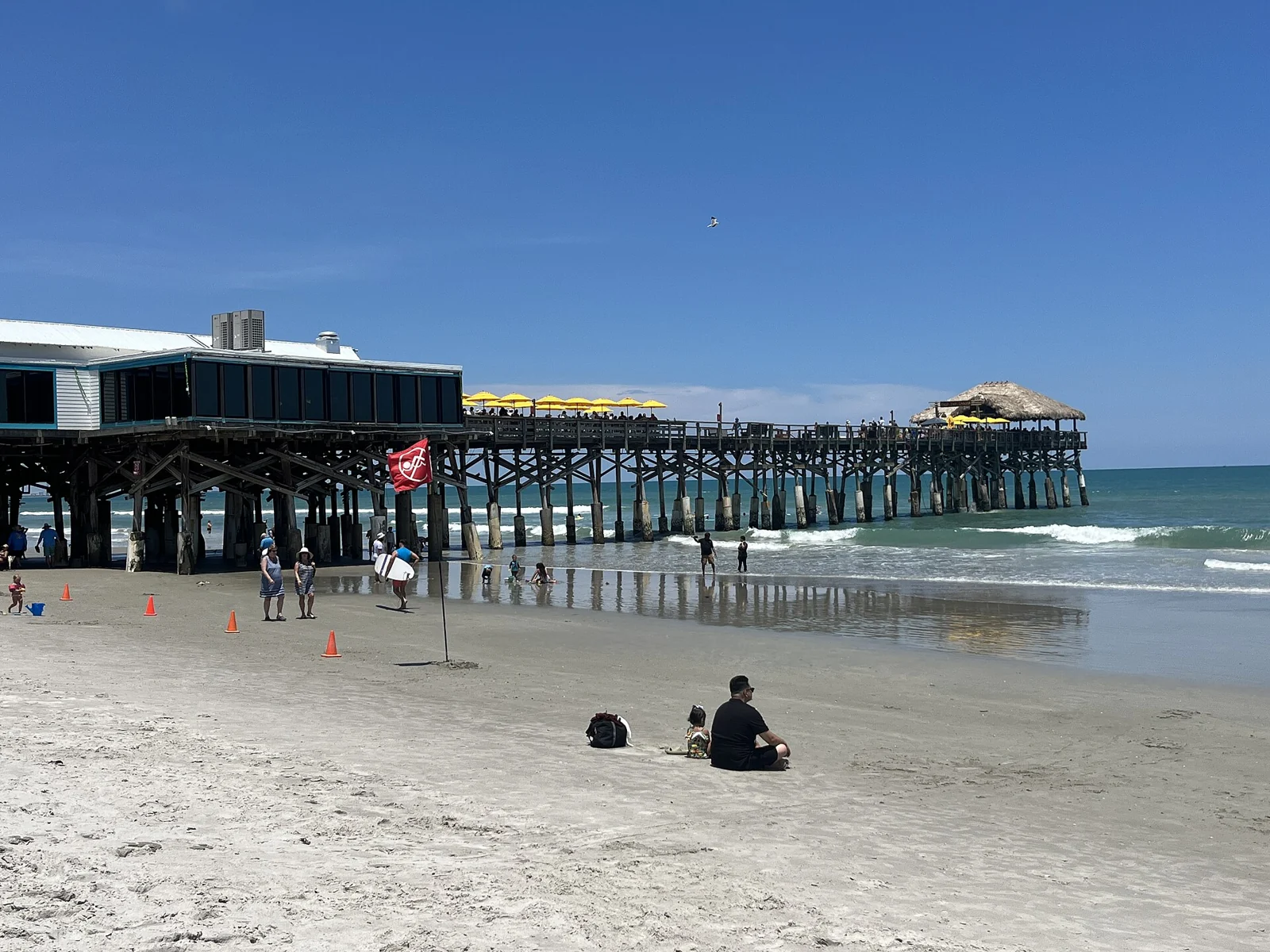 Cocoa Beach Pier seen from the beach, photographed in May 2023.