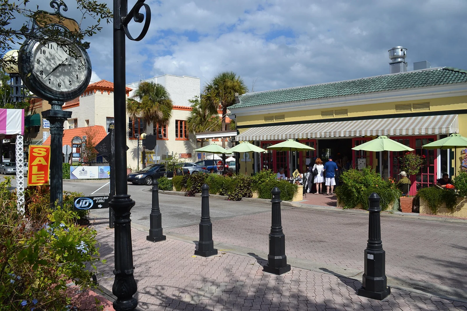 A street scene in Historic Cocoa Village with a clock and outdoor tables, photographed in 2011.